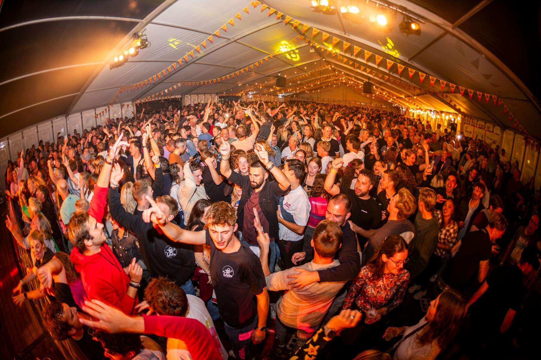 Volle feesttent met juichend publiek